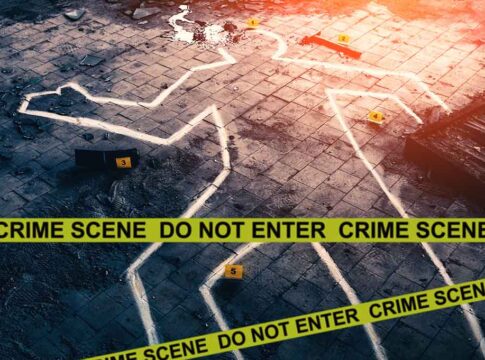 Crime scene with chalk outline and evidence markers.