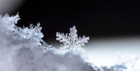 Close-up of a single snowflake with intricate details.