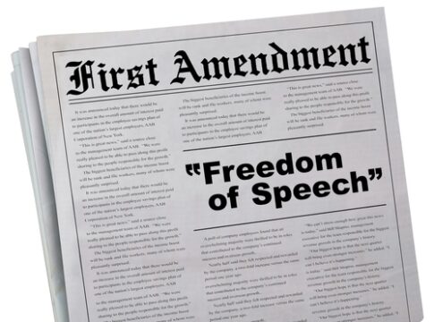 Newspaper headline about the First Amendment and freedom.