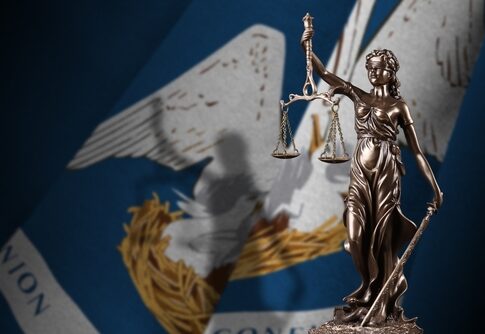 Lady Justice statue with Louisiana state flag background.