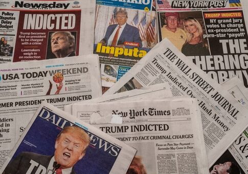 Newspapers with headlines about Donald Trumps indictment.