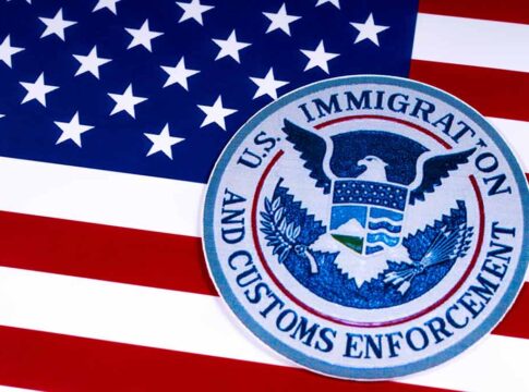 U.S. Immigration and Customs Enforcement emblem on American flag.