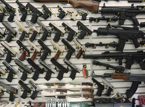 Gun display wall with various pistols and rifles.