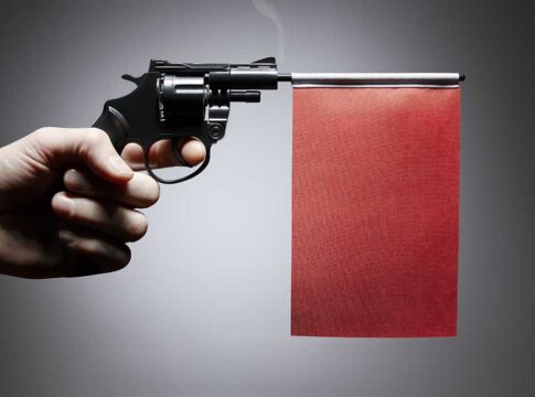 Gun with a red flag attachment, presented sideways.