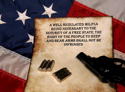 USA flag with Second Amendment, bullets, and revolver.