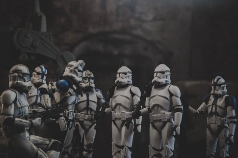 Clone troopers gathered in dark, atmospheric setting.