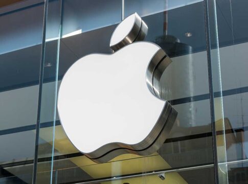 Large Apple logo on glass building facade.