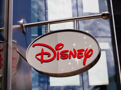 Disney sign with stars on a building.