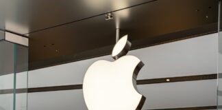 Illuminated Apple logo inside a store.