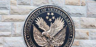Department of Veterans Affairs seal on a stone wall.
