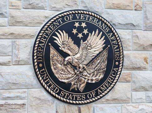 Department of Veterans Affairs seal on a stone wall.