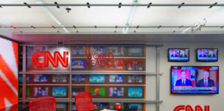 CNN World Headquarters studio with empty red chairs.