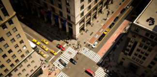 Aerial view of busy city intersection with crosswalks.