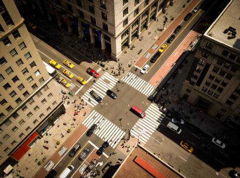 Aerial view of busy city intersection with crosswalks.