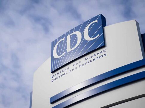 CDC sign on building with cloudy sky background.