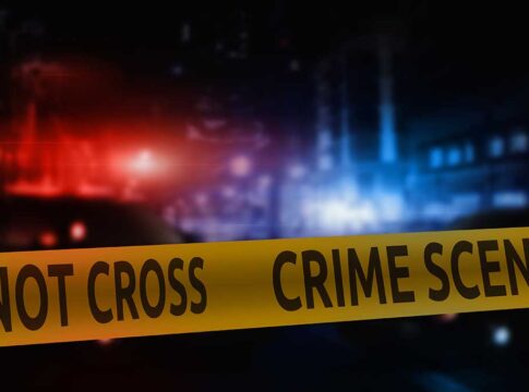 Police crime scene tape with flashing lights background.