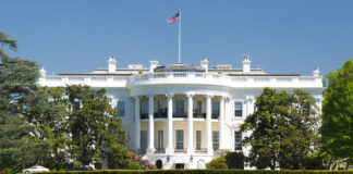 The White House with American flag above it.