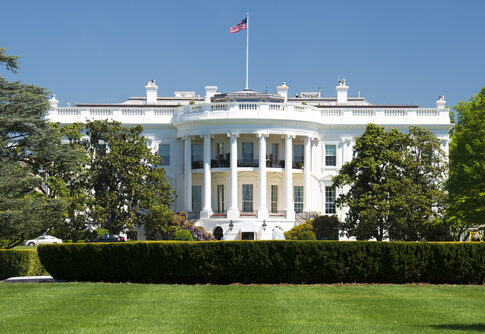 The White House with American flag above it.