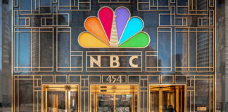 NBC building entrance with colorful peacock logo.