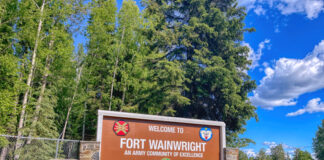 Sign for Fort Wainwright, an Army community, outdoors.