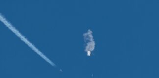 Aircraft intercepting an airborne object releasing smoke.