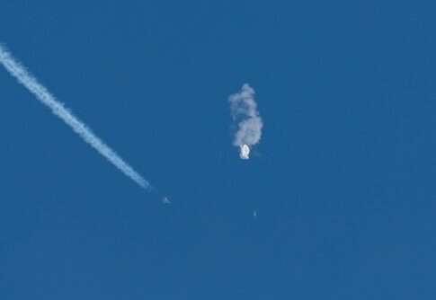 Aircraft intercepting an airborne object releasing smoke.