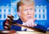 Gavel in front of a blurred person pointing