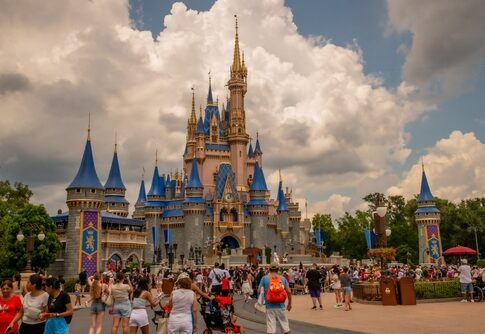 Crowd at Magic Kingdom's Cinderella Castle on a cloudy day.