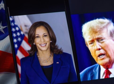 Two political figures on phone screens with American flag