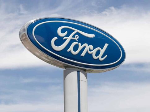 Blue Ford logo sign against the sky.