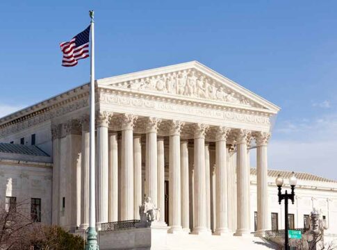 United States Supreme Court building with American flag.