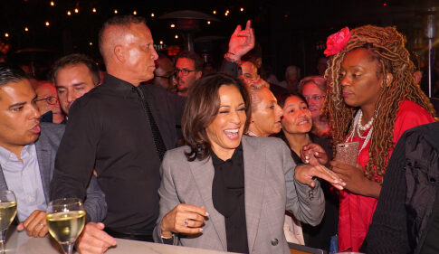 Kamala Harris smiling in a crowd at an event.