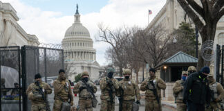 Soldiers standing guard in front of United States Capitol.