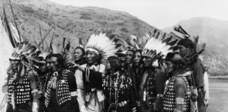 A group of Indigenous people wearing traditional attire.