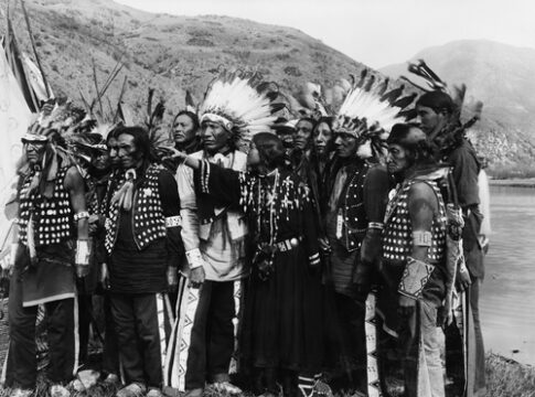 A group of Indigenous people wearing traditional attire.