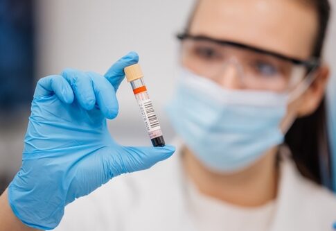 Medical professional holding a blood sample in a laboratory