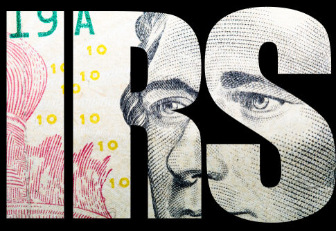 Close-up of a banknote featuring the letters IRS